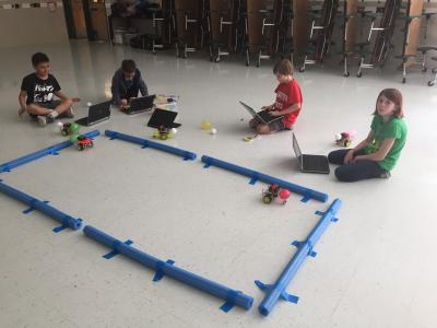 Photo of students racing balloons on robotic cars