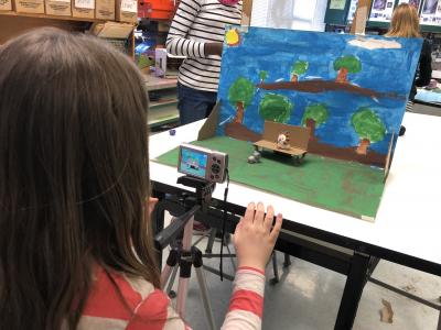 photo of students taking photos of a  mini painted set