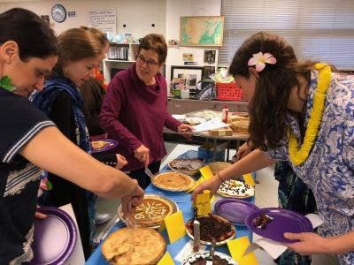  photos of teachers wearing beach garb and cutting pies to eat