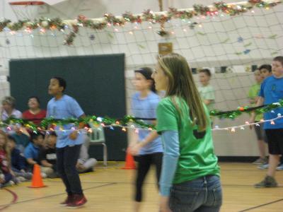 photo of students and teachers playing volleyball in the gym