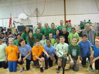 photo of sixth grade student volleyball team and teachers they opposed, posing as a team