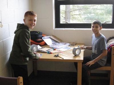 photo of students working and creating things at a table 