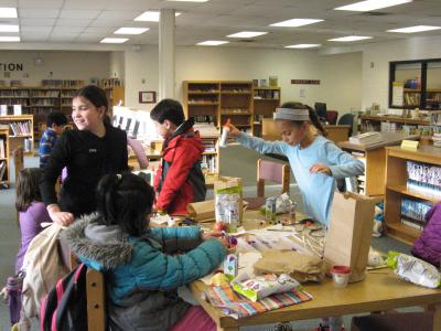 photo of students working and creating things at a table 