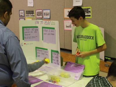 photo of parents and students interacting with science and math game displays