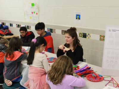 photo of parents and students interacting with science and math game displays