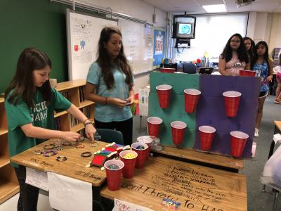 photo of students standing by desks with handmade items 