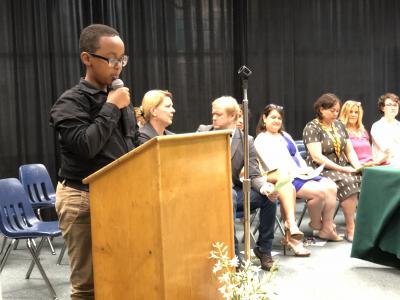 photo of student at podium on stage