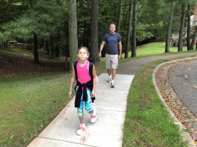 photo of student walking to school with parent