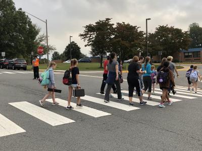 photo of students walking to school crossing the street