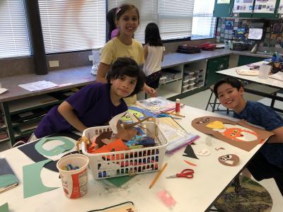 photo of students working with construction paper to create animal faces