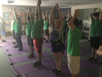 photo of students standing on yoga mats